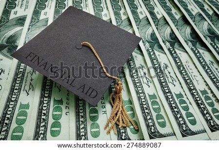 graduation cap with Financial Aid text on assorted hundred dollar bills