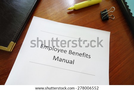 Employee Benefits Manual on an office desk
