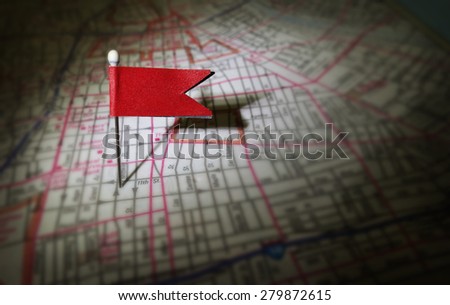 Red flag pin in urban street map