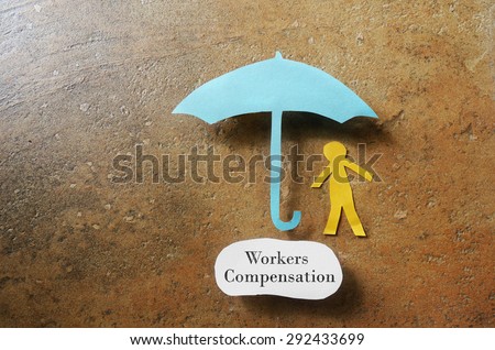 Paper man under an umbrella with Workers Compensation note underneath -- on the job injury concept