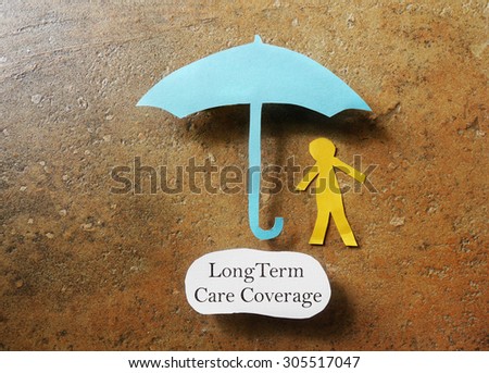 Paper person under an umbrella with Long Term Care Coverage text -- elder care insurance concept