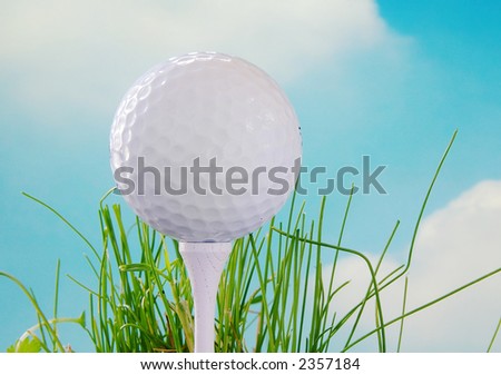 Golf ball on the tee and blue sky background