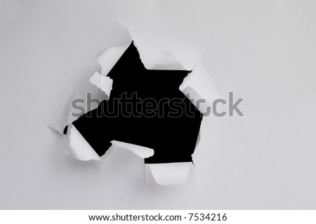 Hole ripped inward on a piece of paper