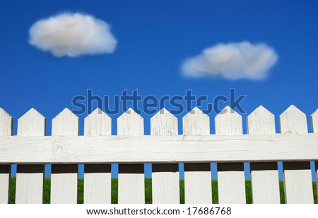 White picket fence, green grass and sky