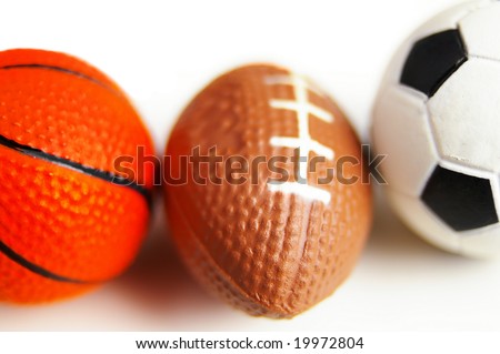closeup of a football, soccer ball and basketball, on white