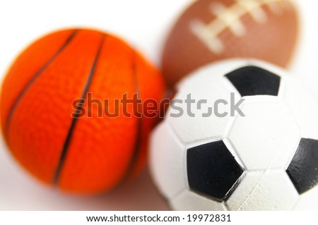 closeup of soccer ball, football, and basketball, on white