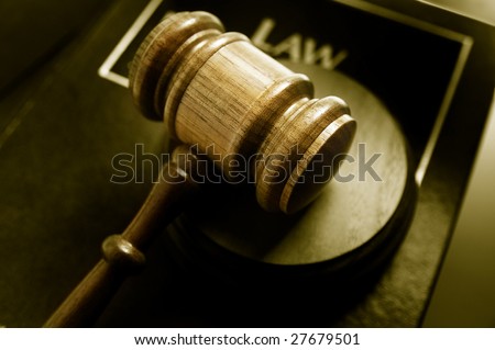 court gavel and law book, closeup from above