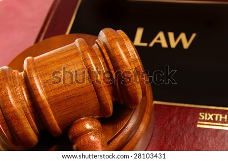 law book and judges gavel closeup from above