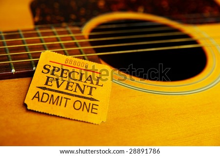 Closeup  of a special event ticket stub on a guitar