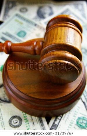 closeup of judges court gavel, over american money