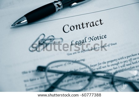 legal contract law papers with pen and glasses