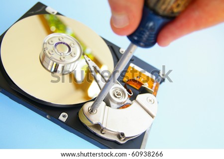 pc technician repairing a computer hardrive