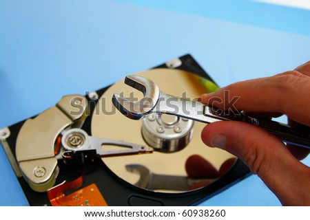 PC technician repairing a  computer hard-drive