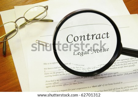 legal contract with magnifying glass and glasses