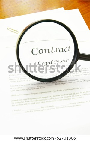 legal contract and magnifying glass