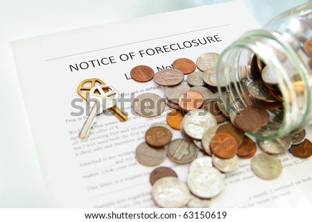 bank foreclosure notice and spilled coin jar