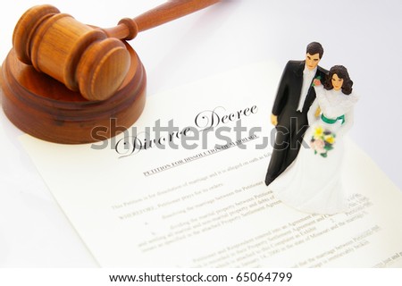cake-topper wedding couple, divorce agreement and a gavel