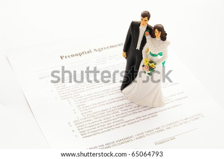 stock photo caketopper wedding couple and a prenuptial agreement