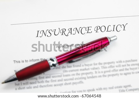 generic insurance policy with pen; could be life, auto, health etc