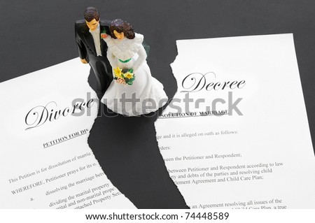 stock photo caketopper wedding couple on a torn divorce document