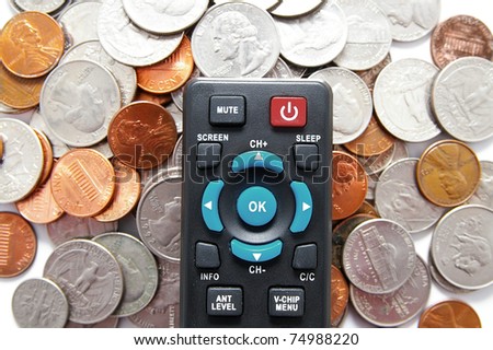 tv remote control and pile of coins