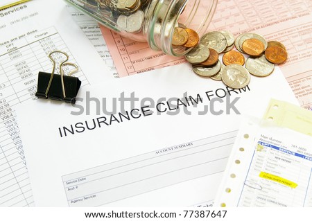 Assorted medical bills and a claim form with coins