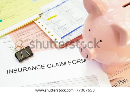 Assorted medical bills and a claim form, with piggy bank