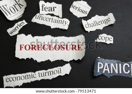 Newspaper headlines showing Foreclosure and bad economic news