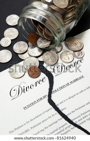 torn divorce agreement and money from a coin jar