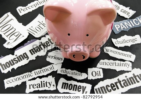 torn newspaper headlines showing bad news with piggy bank