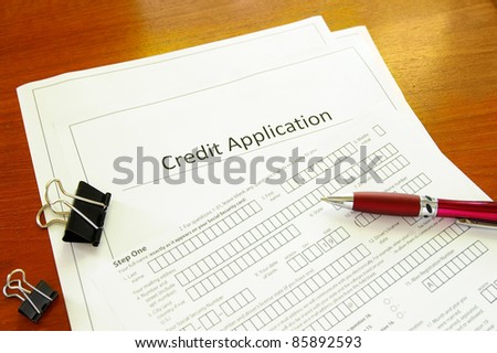 Blank credit application form with pen and clips - stock photo Blank credit application form with pen and clips - stock photo