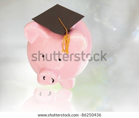 piggy bank with graduation cap ( education costs )