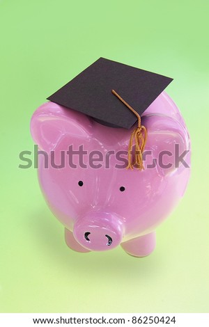 piggy bank with graduation cap on green ( cost of education )