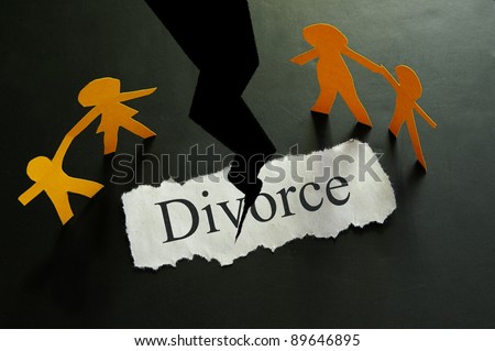 torn piece of paper with divorce text and paper family figures
