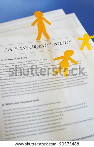 life insurance policy and paper cutout family