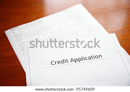 blank credit application form on a desk - stock photo blank credit application form on a desk - stock photo