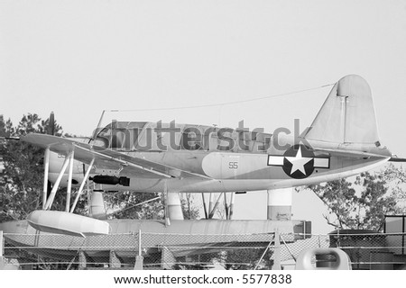 Small plane on the deck of a WWII battleship.