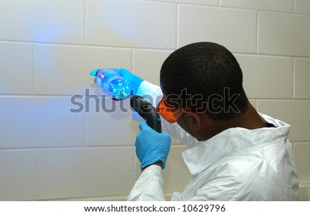 Forensic scientist working on a piece of evidence in the lab.