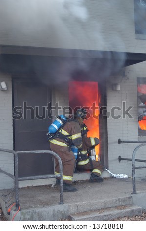 Firemen working at a apartment fire.
