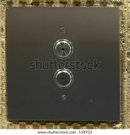 Wall panel with up and down elevator buttons - no arrows.