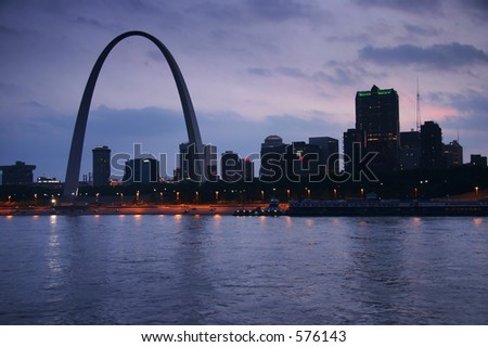 Evening shot of the St. Louis Gateway Arch in MO from across the Mississippi, in IL.  The view is over the river, and gives a nice skyline of St. Louis.