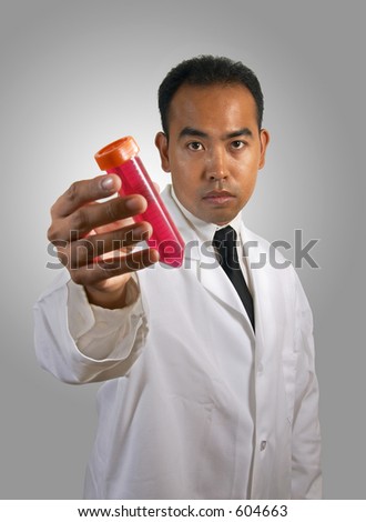 stock photo AsianAmerican Filipino holding a test tube with red media