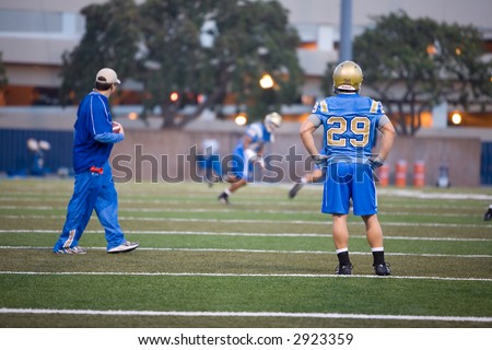 UCLA Bruins football players practicing on field