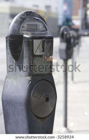 Vertical image of a row of parking meters in downtown Los Angeles