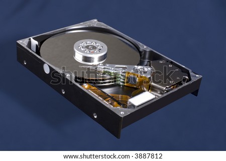 Horizontal image of a Hard Disk Drive, opened up.