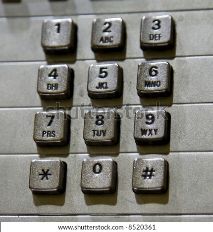 Close up image of a public pay phone keypad