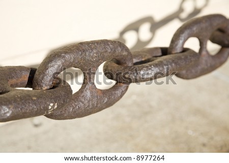 Horizontal image of a  rusted chain typically used in boat anchors