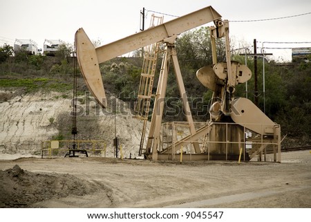 Image of a pumpjack type oil pump.  Also known as a nodding horse, nodding donkey, thirsty bird, beam pump or horsehead pump.