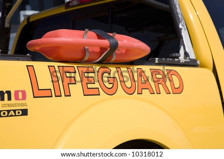 Horizontal image of a lifeguard truck with a rescue buoy