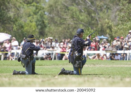 HUNTINGTON BEACH, CA Aug 30:  Civil war re-enactors portraying Union Soldiers firing their carbines with an audience of spectators watching.